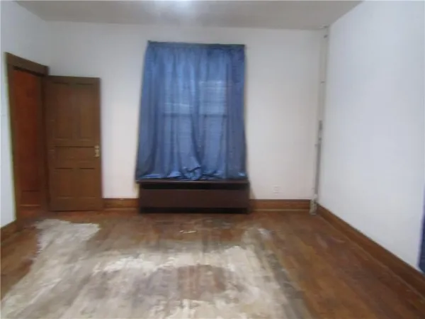 a view of an empty room with a fireplace