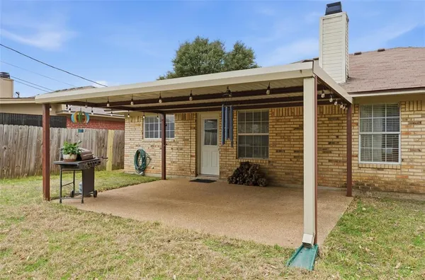 a view of a house with backyard porch and furniture