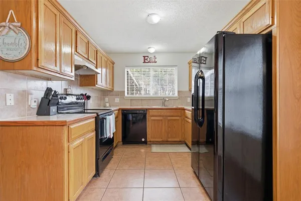 a kitchen with stainless steel appliances granite countertop a refrigerator and a stove