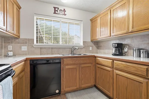 a kitchen with cabinets appliances and a sink