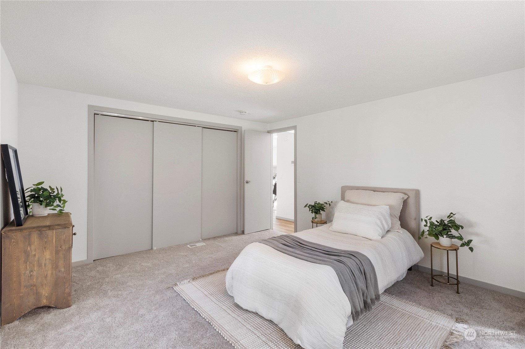 18441 Elaine Court Southwest Rochester, WA 98579 - Photo 21 of 30 a bedroom with a bed and a potted plant