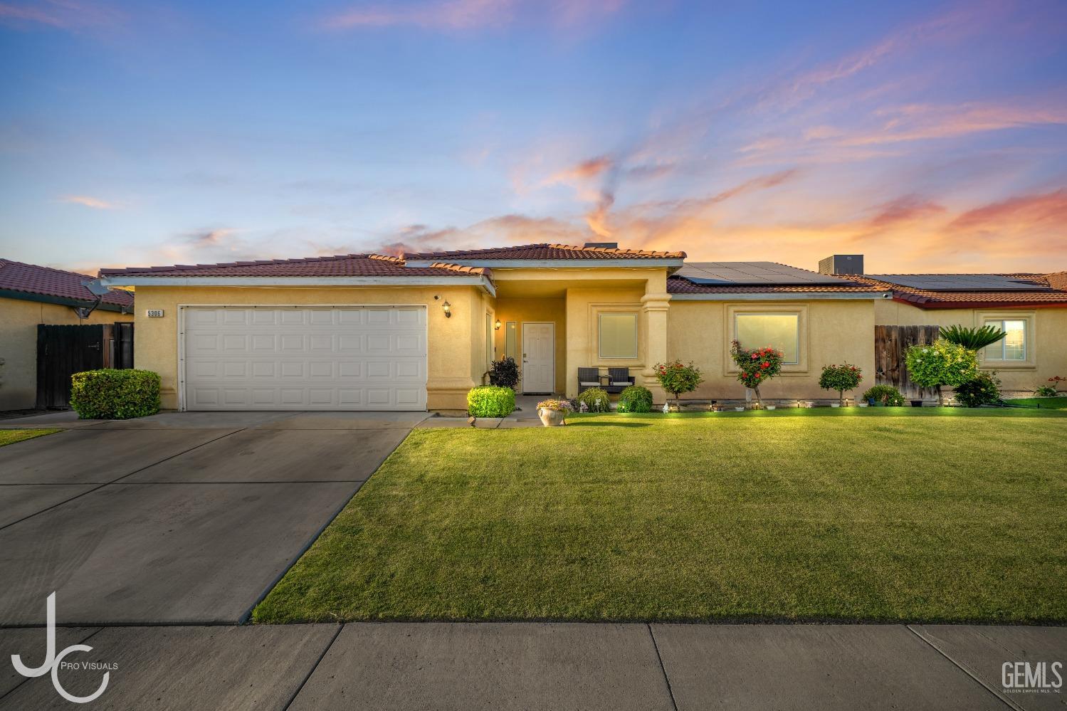 a front view of house with yard and outdoor seating