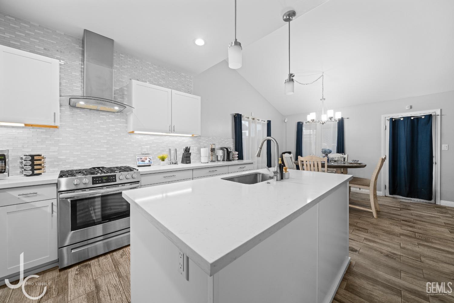 Undisclosed Address Bakersfield, CA 93307 - Photo 11 of 31 a large kitchen with stainless steel appliances and a center island