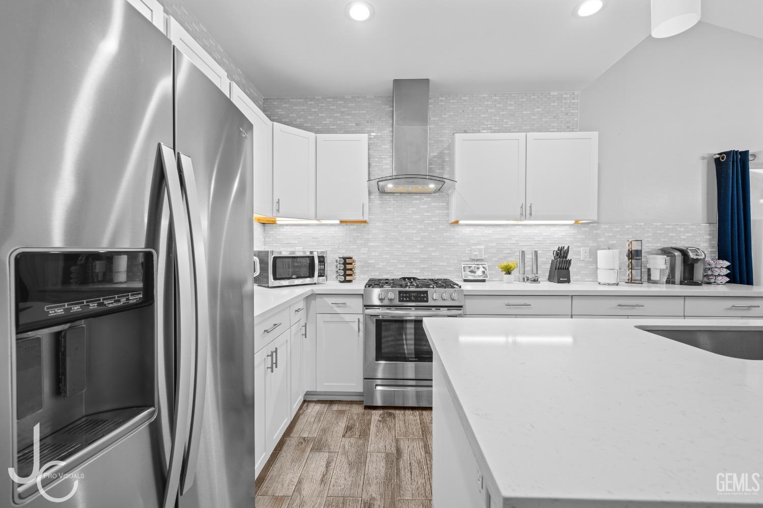 Undisclosed Address Bakersfield, CA 93307 - Photo 13 of 31 a kitchen with a refrigerator stove and sink