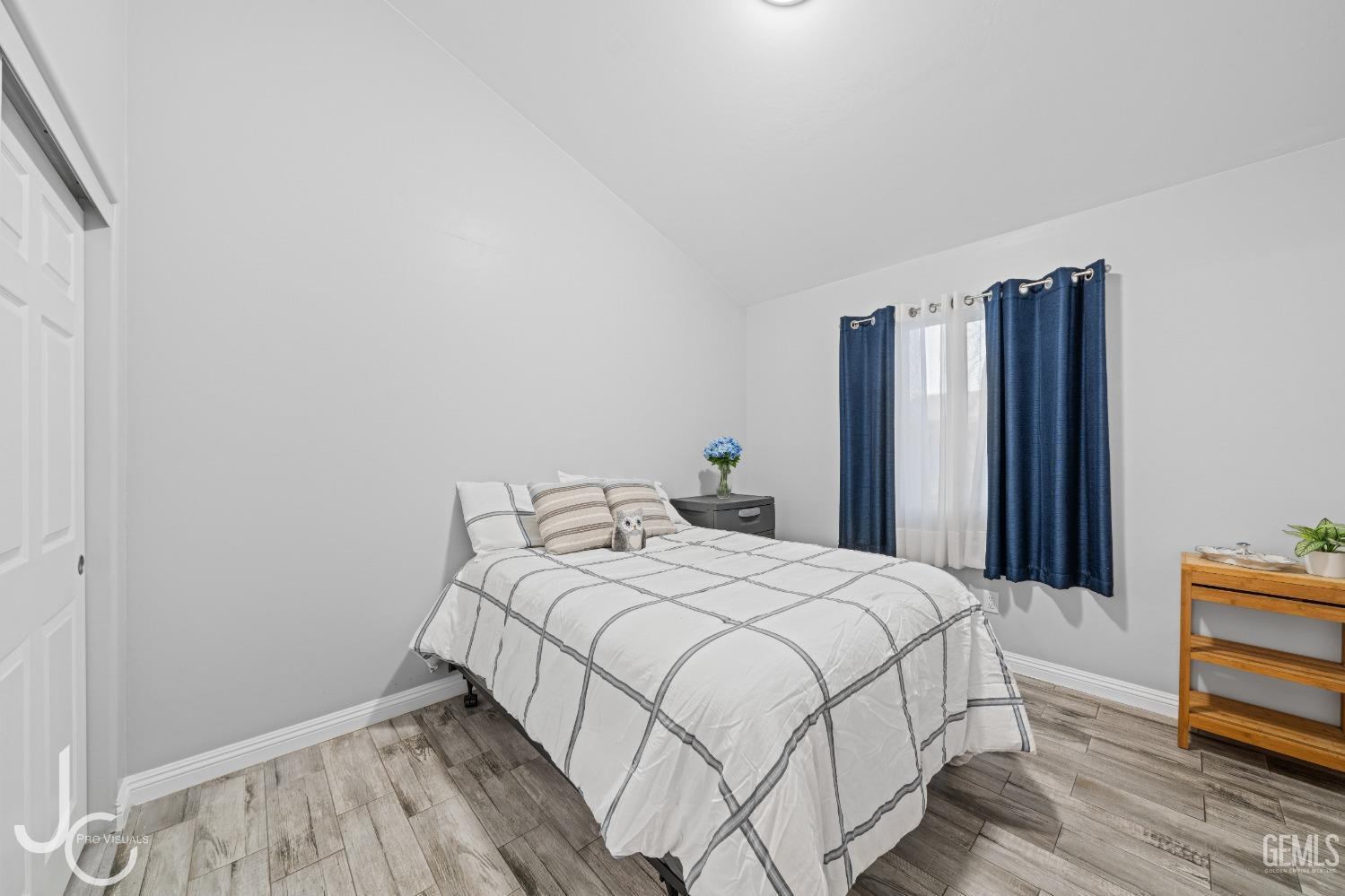 Undisclosed Address Bakersfield, CA 93307 - Photo 18 of 31 a bedroom with a bed table and a large mirror