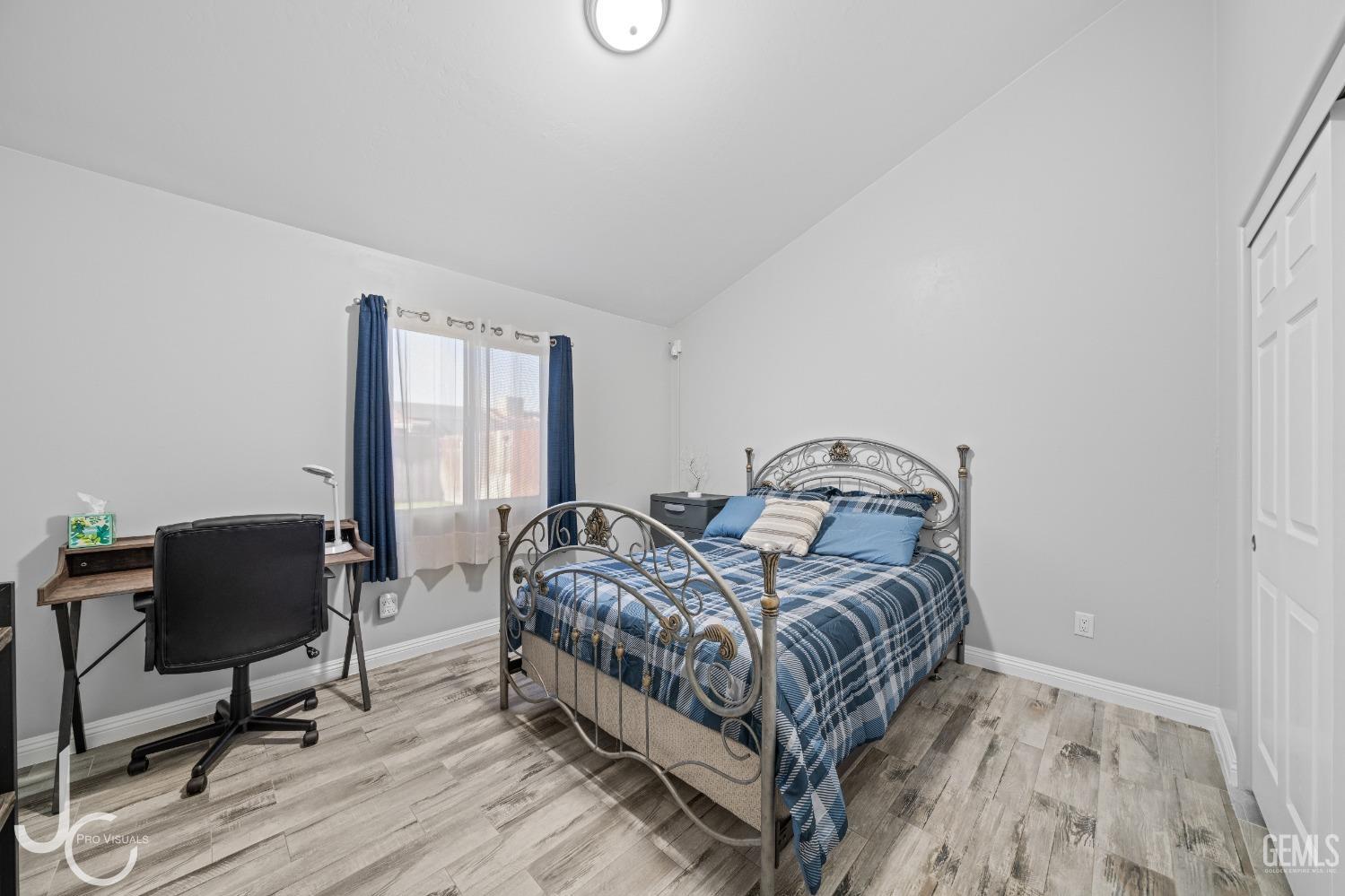 Undisclosed Address Bakersfield, CA 93307 - Photo 19 of 31 a bedroom with a bed chair and a window