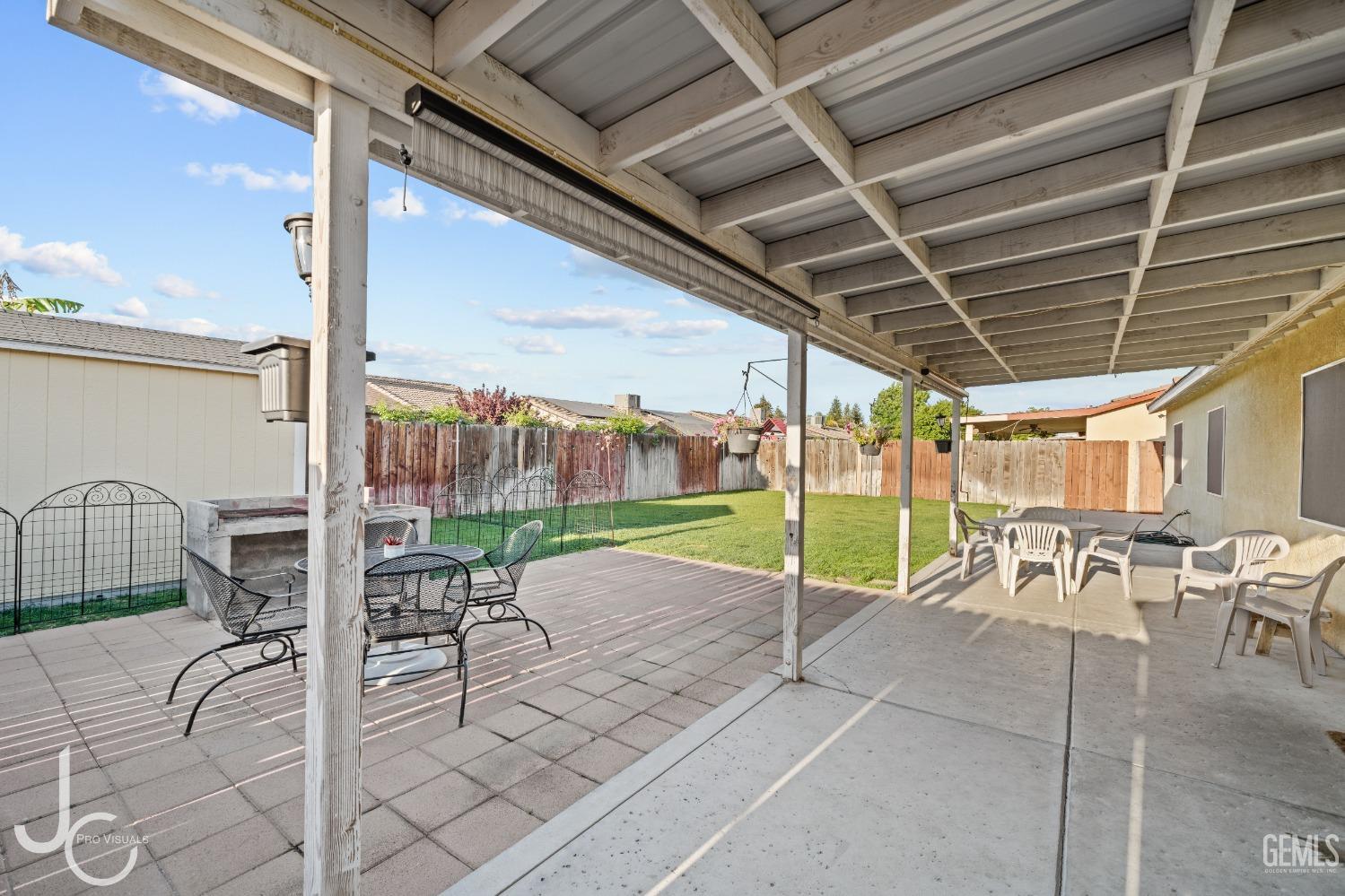 Undisclosed Address Bakersfield, CA 93307 - Photo 26 of 31 a view of a patio with a table chairs and floor to ceiling window
