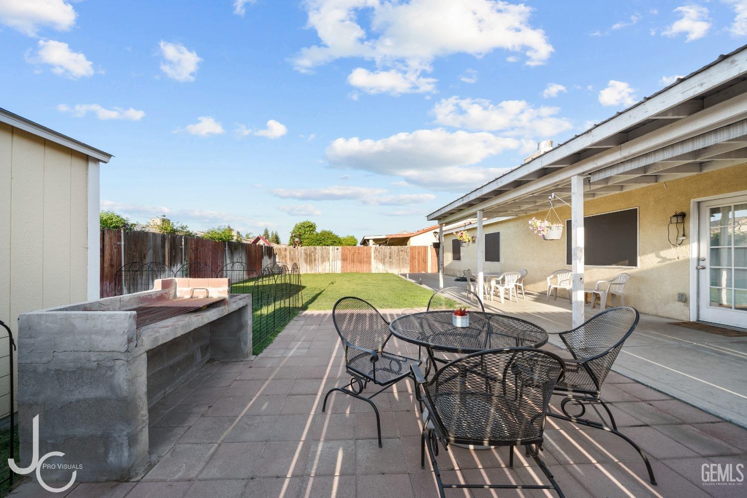 Undisclosed Address Bakersfield, CA 93307 - Photo 27 of 31 a view of a patio with table and chairs and potted plants with wooden floor