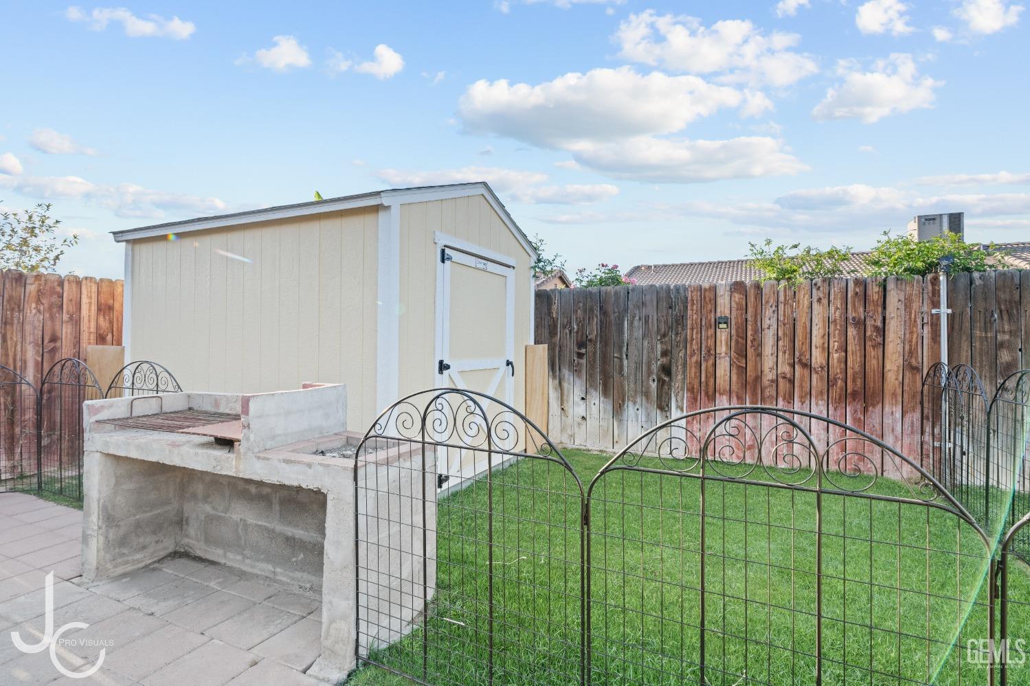 Undisclosed Address Bakersfield, CA 93307 - Photo 28 of 31 a view of a chairs and table in the backyard