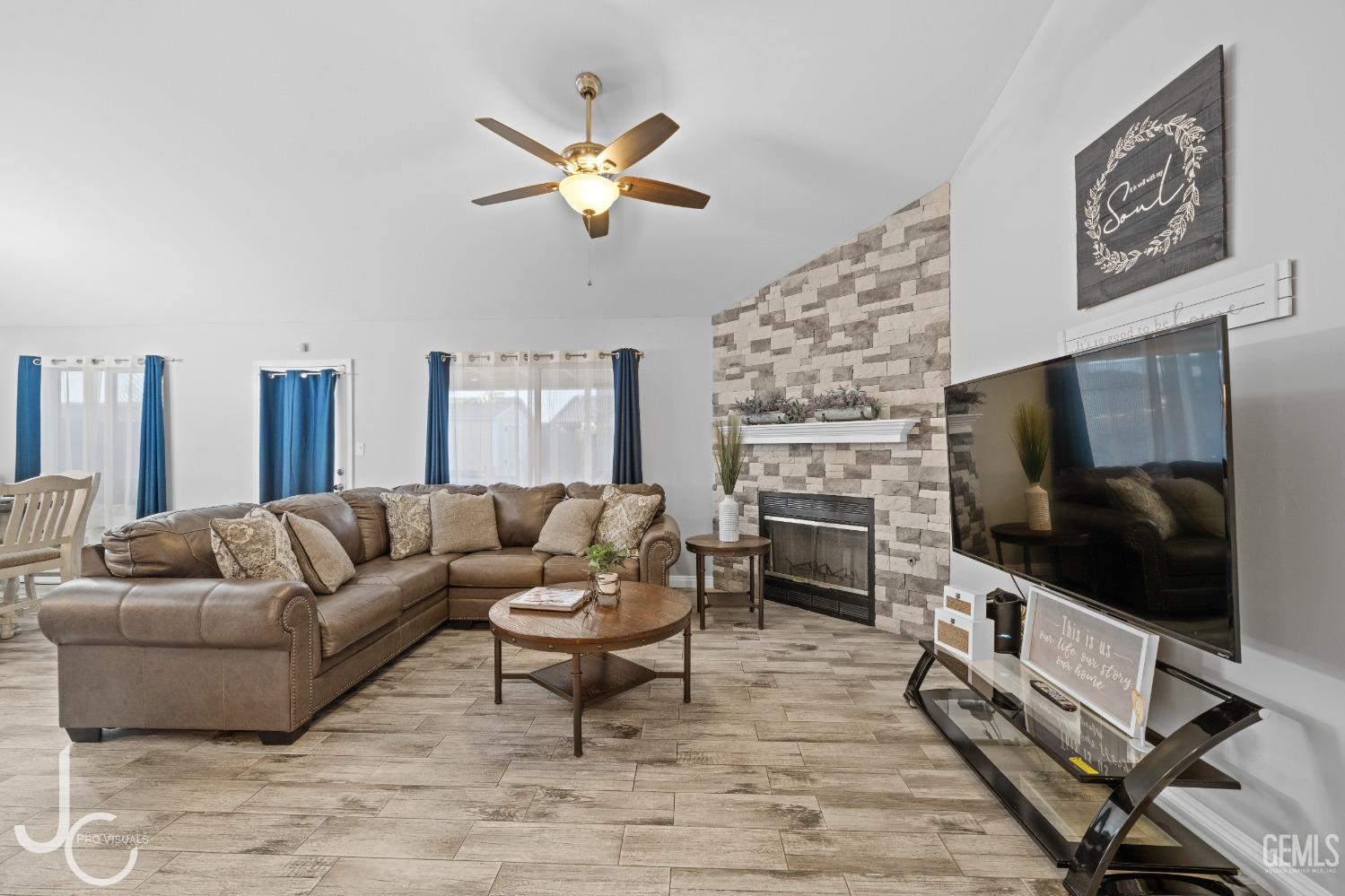 Undisclosed Address Bakersfield, CA 93307 - Photo 4 of 31 a living room with furniture a flat screen tv and a fireplace