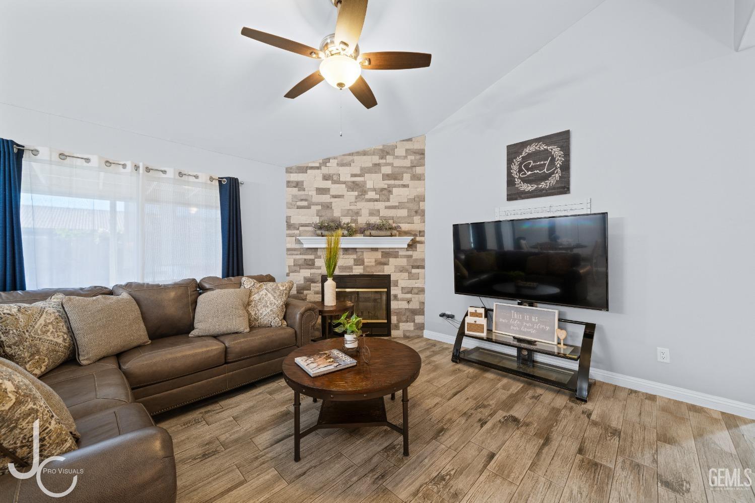 Undisclosed Address Bakersfield, CA 93307 - Photo 5 of 31 a living room with furniture and a flat screen tv