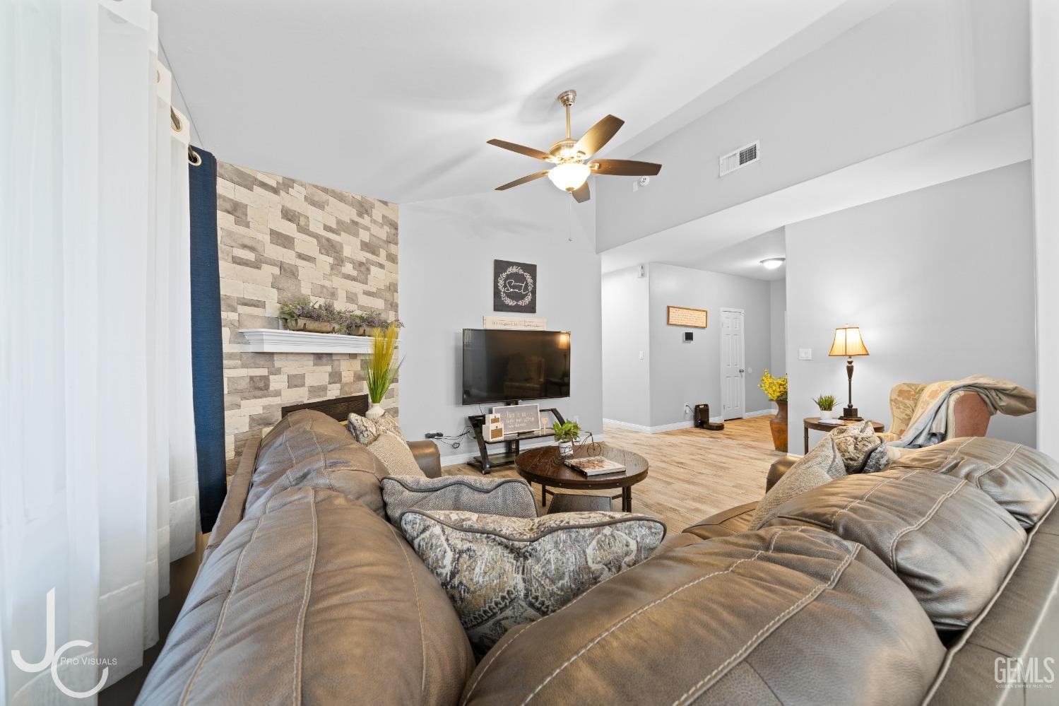 Undisclosed Address Bakersfield, CA 93307 - Photo 6 of 31 a living room with furniture and a flat screen tv