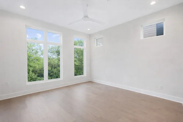 a bedroom with a large bed and a large window