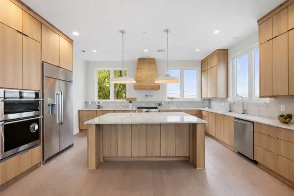 a stove top oven sitting inside of a kitchen