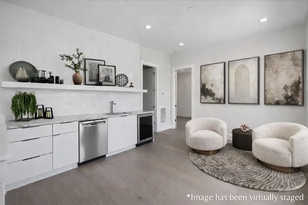 a living room with furniture and a floor to ceiling window