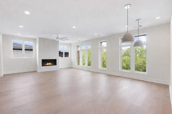 a dining room with furniture a rug and a potted plant