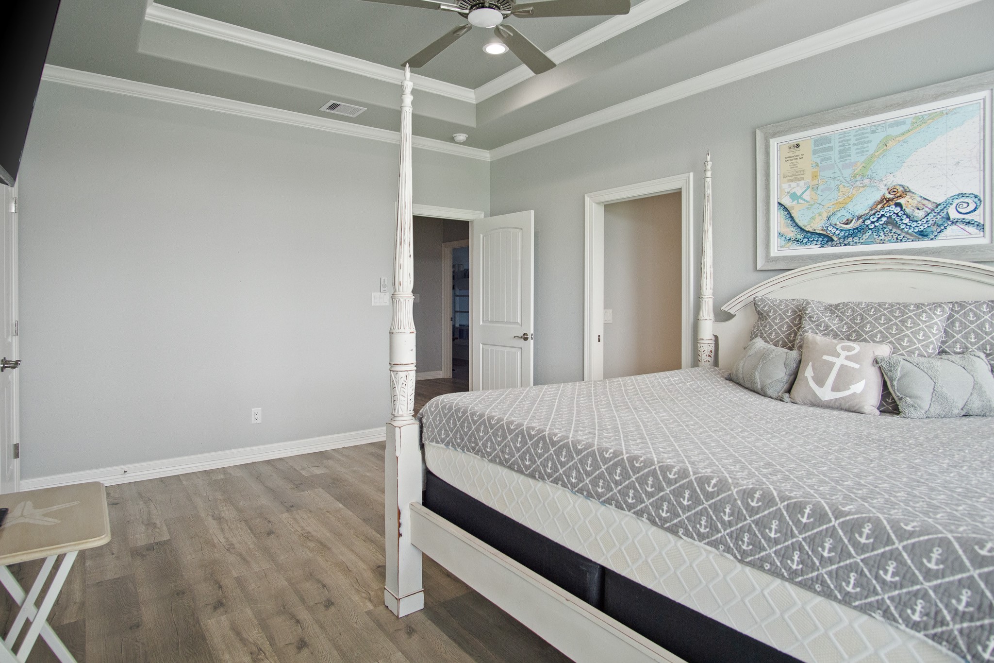 1819 Redfish Lane Crystal Beach, TX 77650 - Photo 13 of 34 a bedroom with a large bed and a chandelier