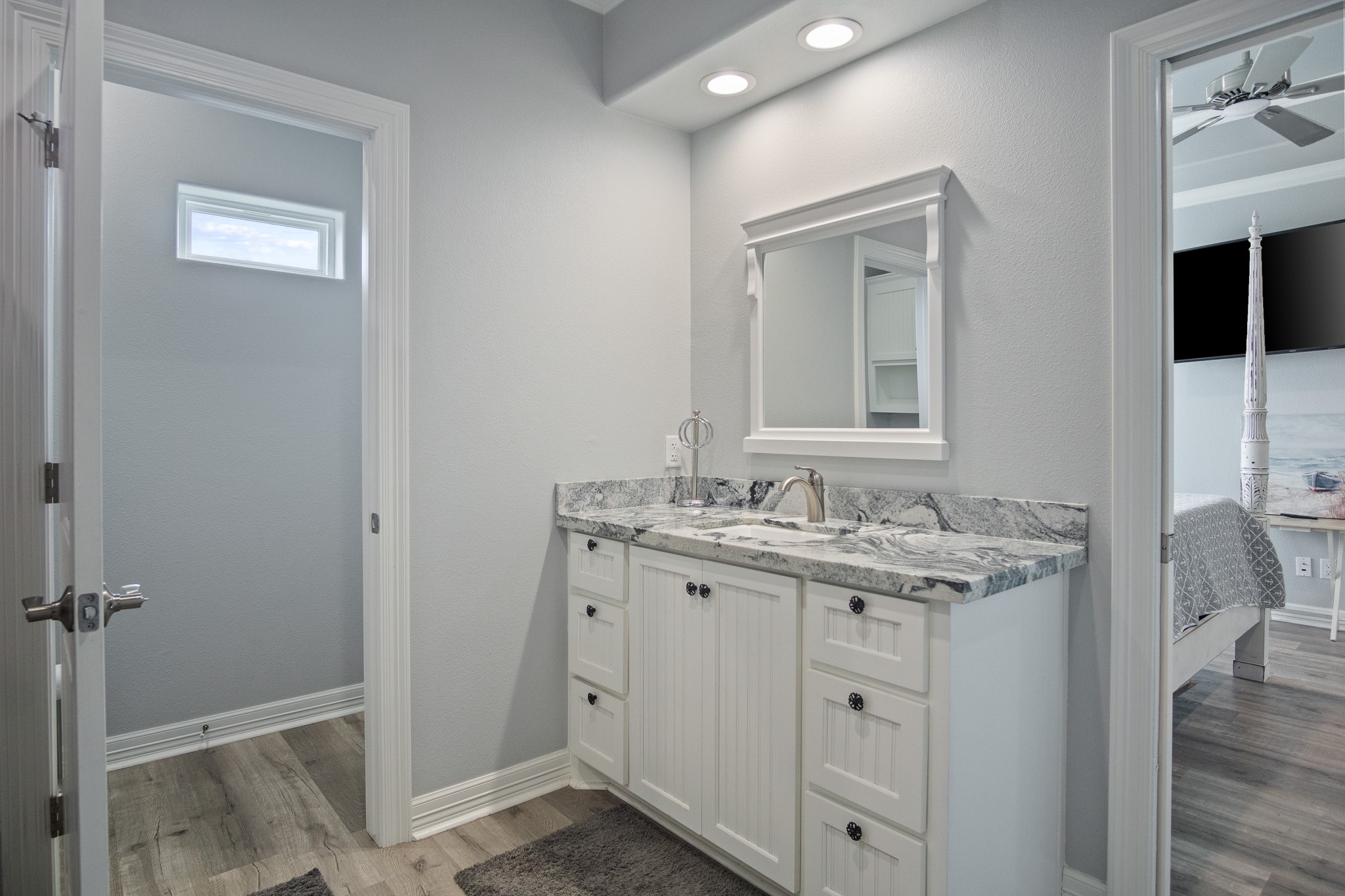 1819 Redfish Lane Crystal Beach, TX 77650 - Photo 15 of 34 a bathroom with a granite countertop sink a toilet and mirror