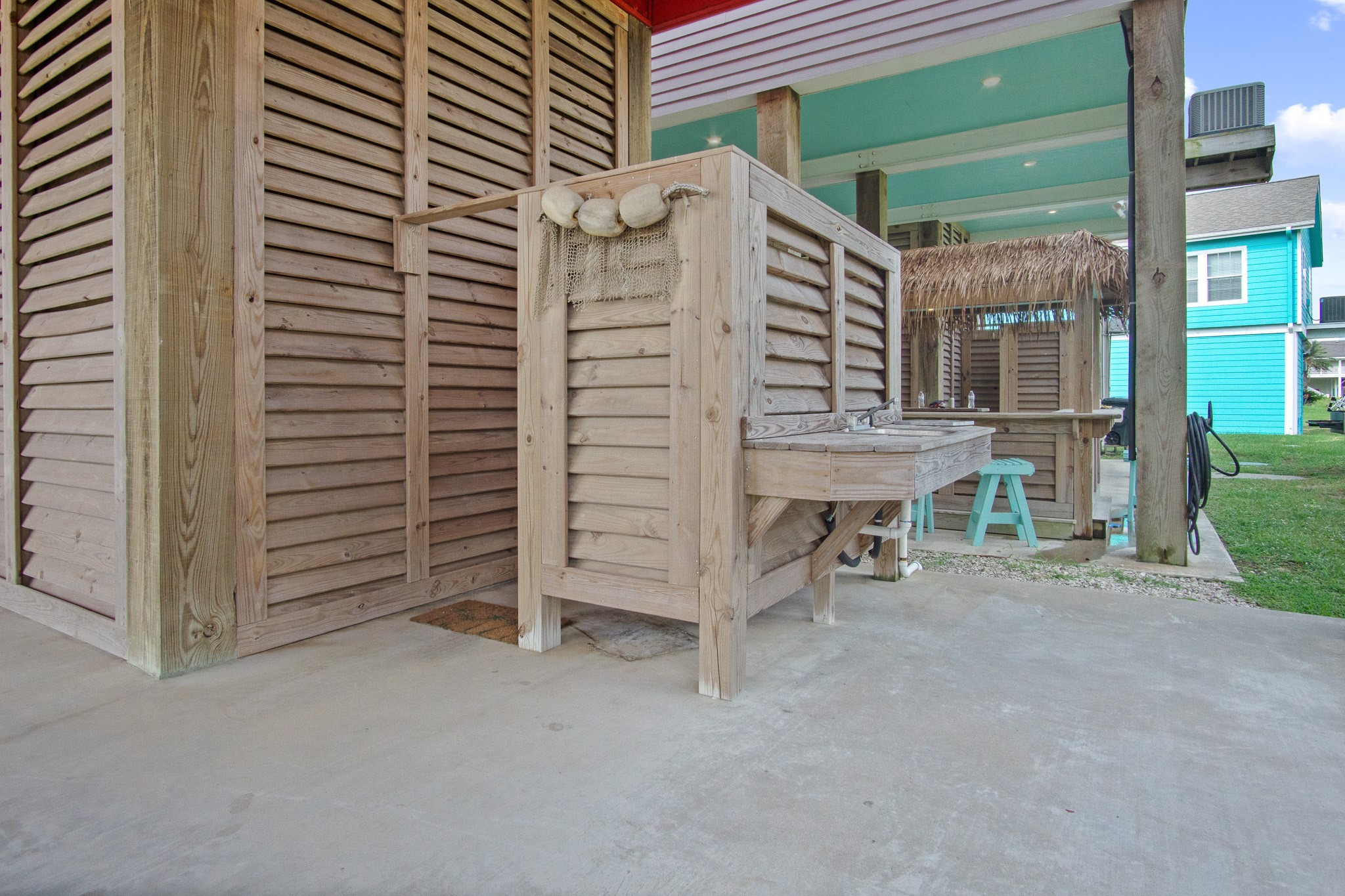1819 Redfish Lane Crystal Beach, TX 77650 - Photo 23 of 34 a view of a patio with table and chairs and a barbeque