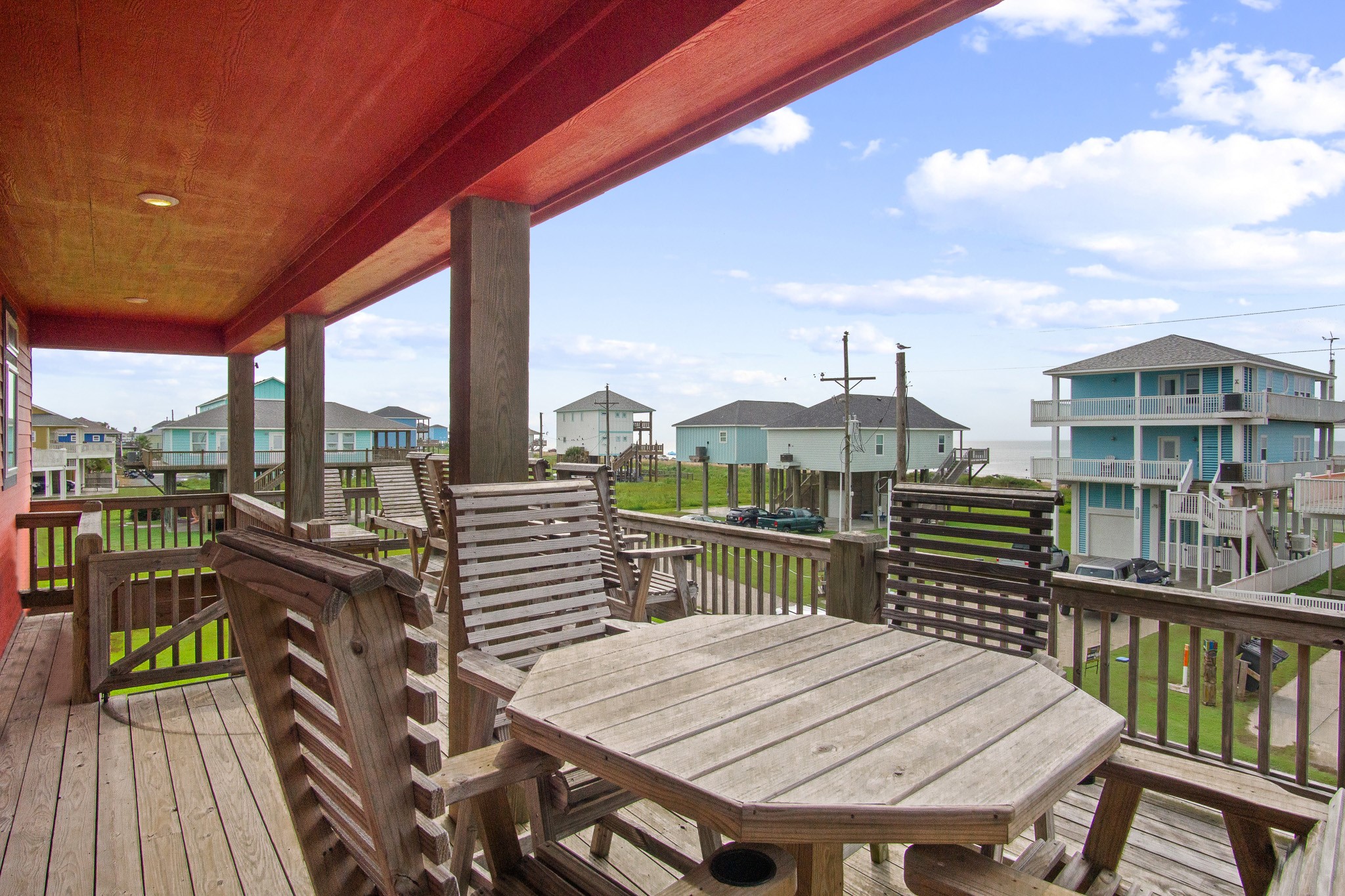 1819 Redfish Lane Crystal Beach, TX 77650 - Photo 29 of 34 a view of a balcony with wooden floor and outdoor seating