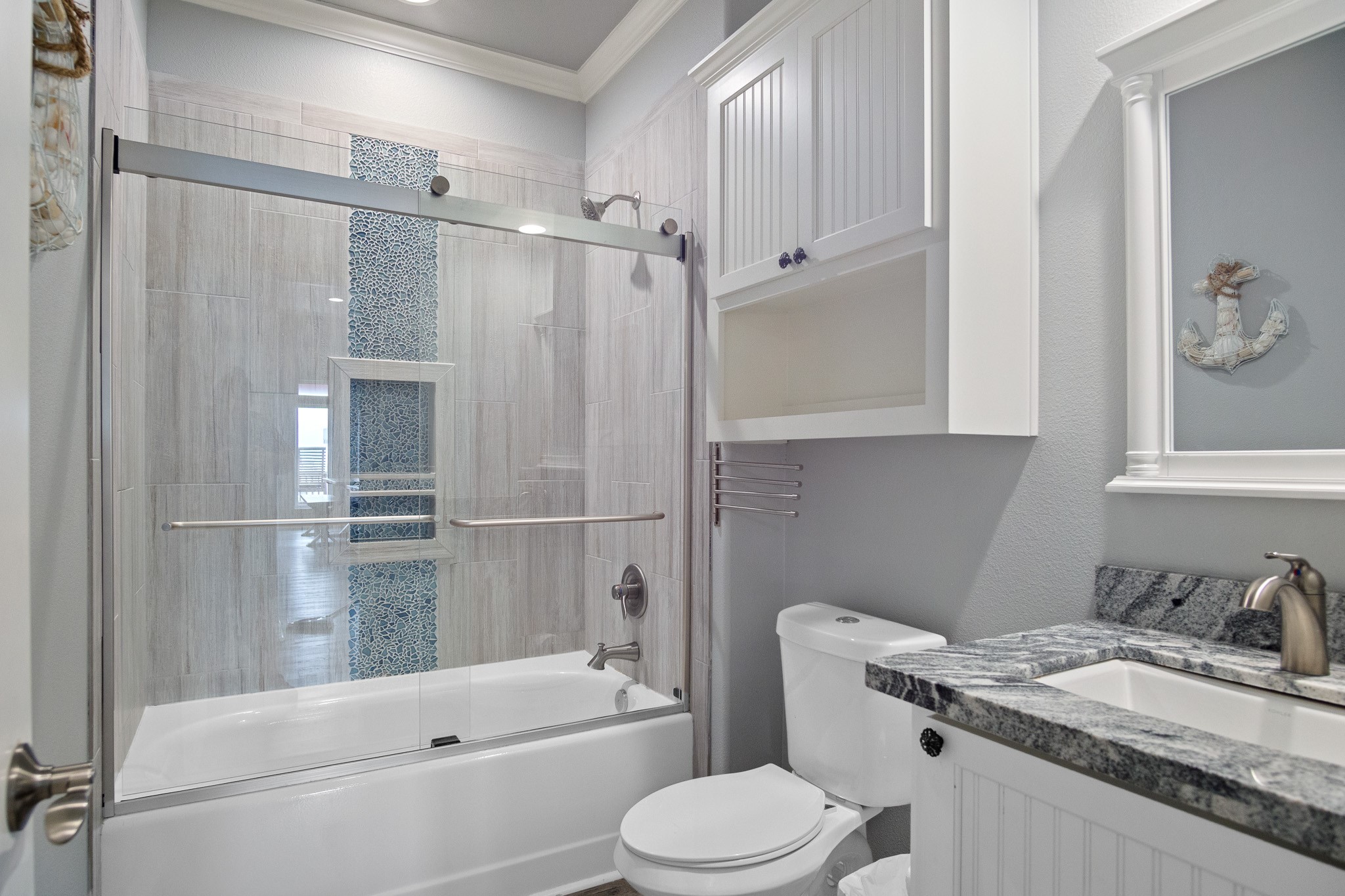 1819 Redfish Lane Crystal Beach, TX 77650 - Photo 33 of 34 a bathroom with a granite countertop bathtub sink vanity mirror and toilet