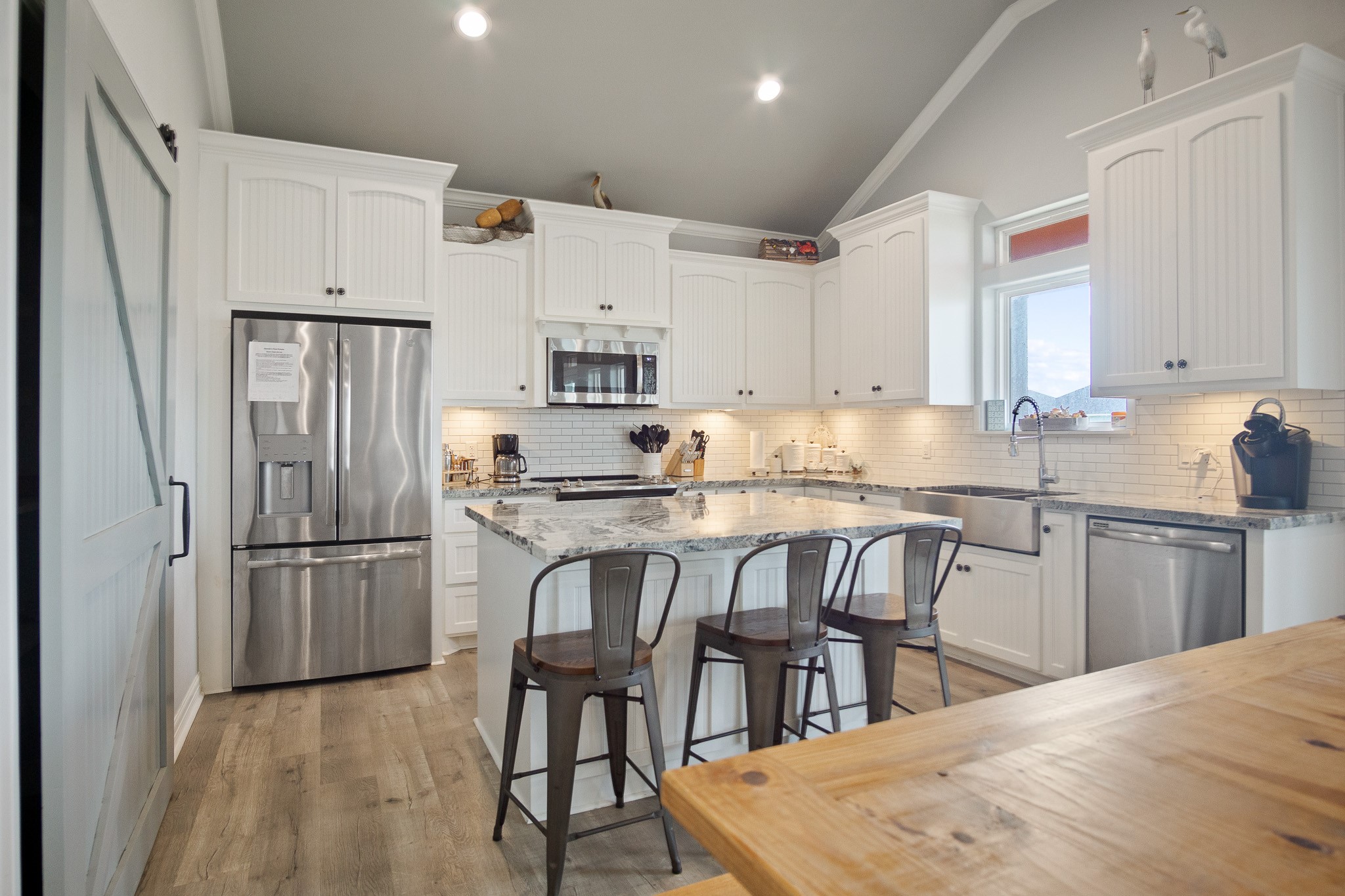 1819 Redfish Lane Crystal Beach, TX 77650 - Photo 5 of 34 a kitchen with granite countertop a refrigerator stove microwave and cabinets