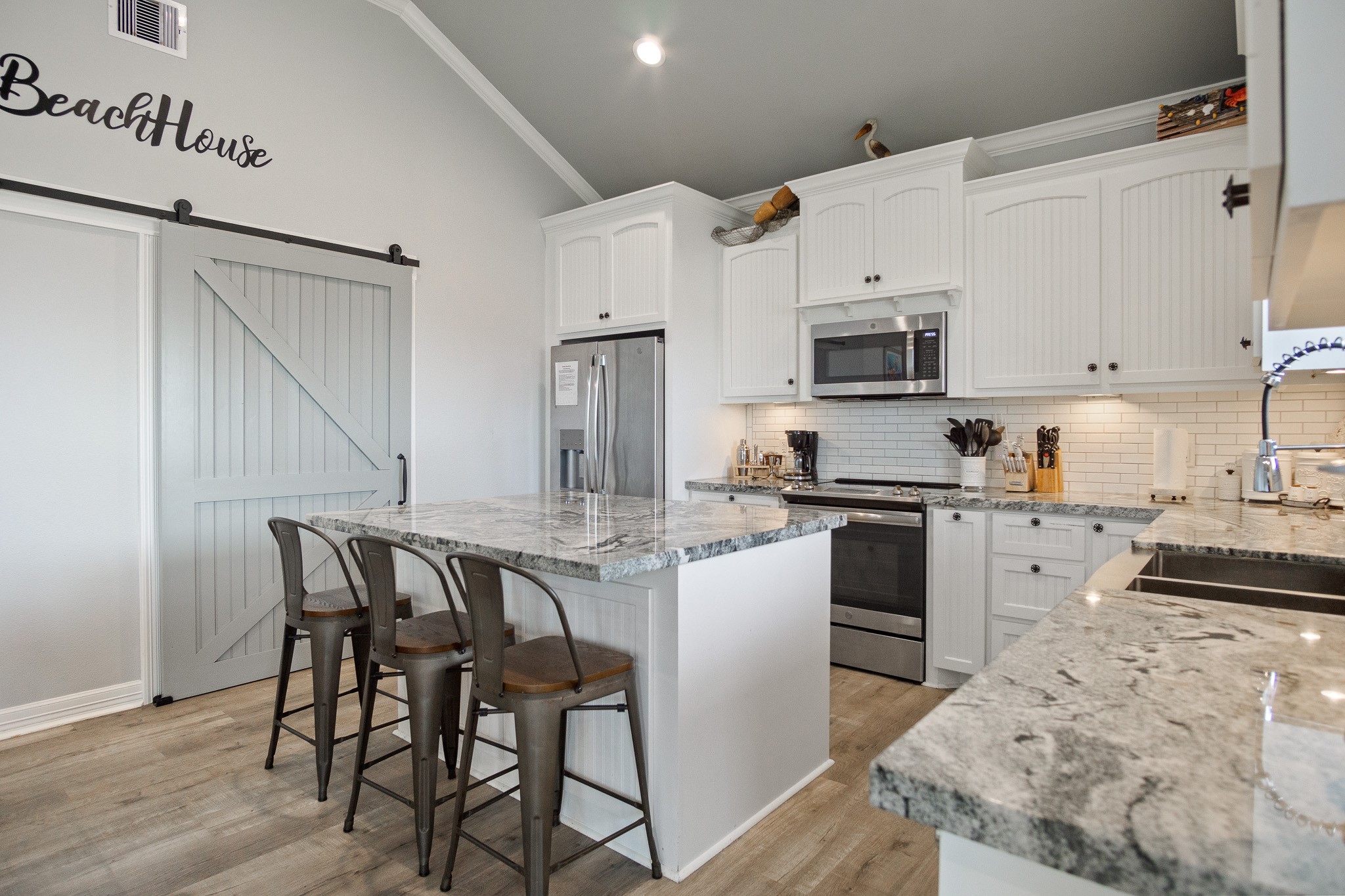 1819 Redfish Lane Crystal Beach, TX 77650 - Photo 7 of 34 a kitchen with granite countertop a stove a sink and a refrigerator