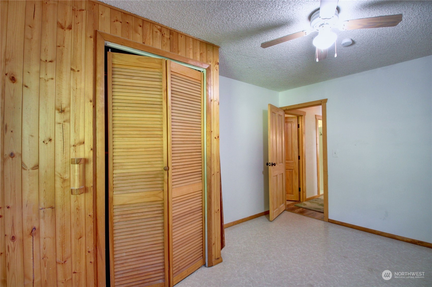 16105 OK Mill Road Snohomish, WA 98290 - Photo 21 of 34 an empty room with closet and a chandelier fan