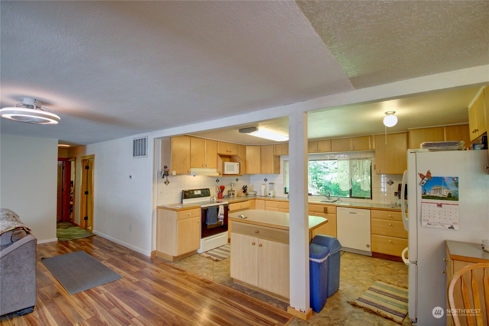 16105 OK Mill Road Snohomish, WA 98290 - Photo 8 of 34 a view of a kitchen with kitchen island wooden floors appliances and furniture