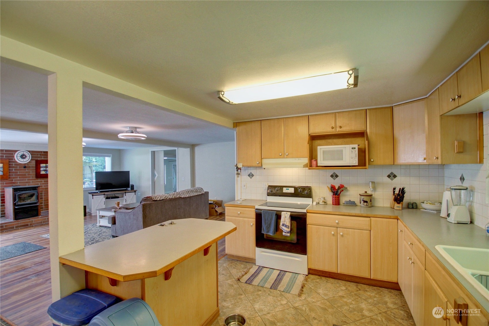 16105 OK Mill Road Snohomish, WA 98290 - Photo 10 of 34 a kitchen with a sink a stove cabinets and wooden floor