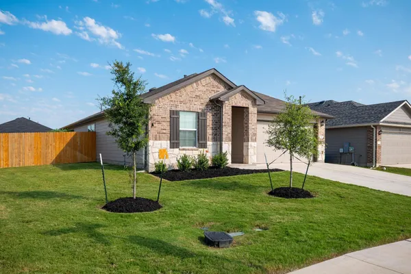 a view of a house with a yard and a garden