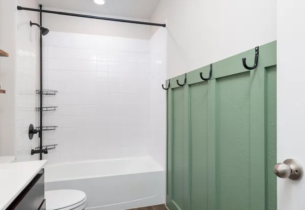 a bathroom with a toilet sink and shower