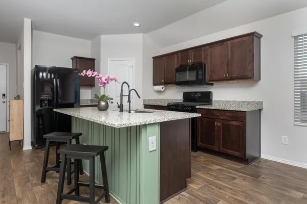 a kitchen with stainless steel appliances granite countertop a stove microwave and oven