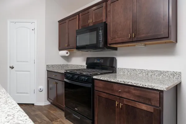 a kitchen with stainless steel appliances granite countertop a sink and refrigerator