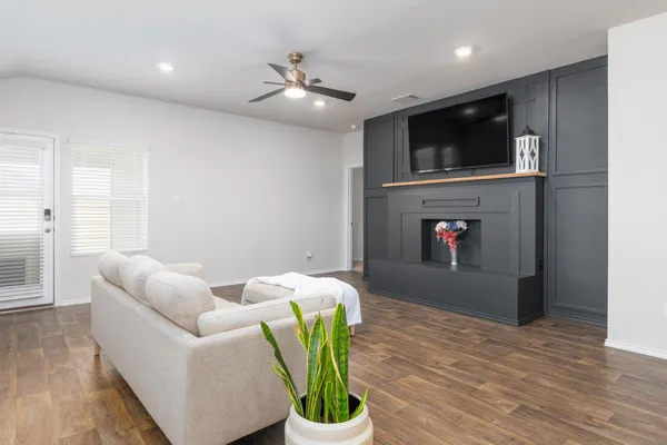 a view of living room with a flat screen tv and a fireplace