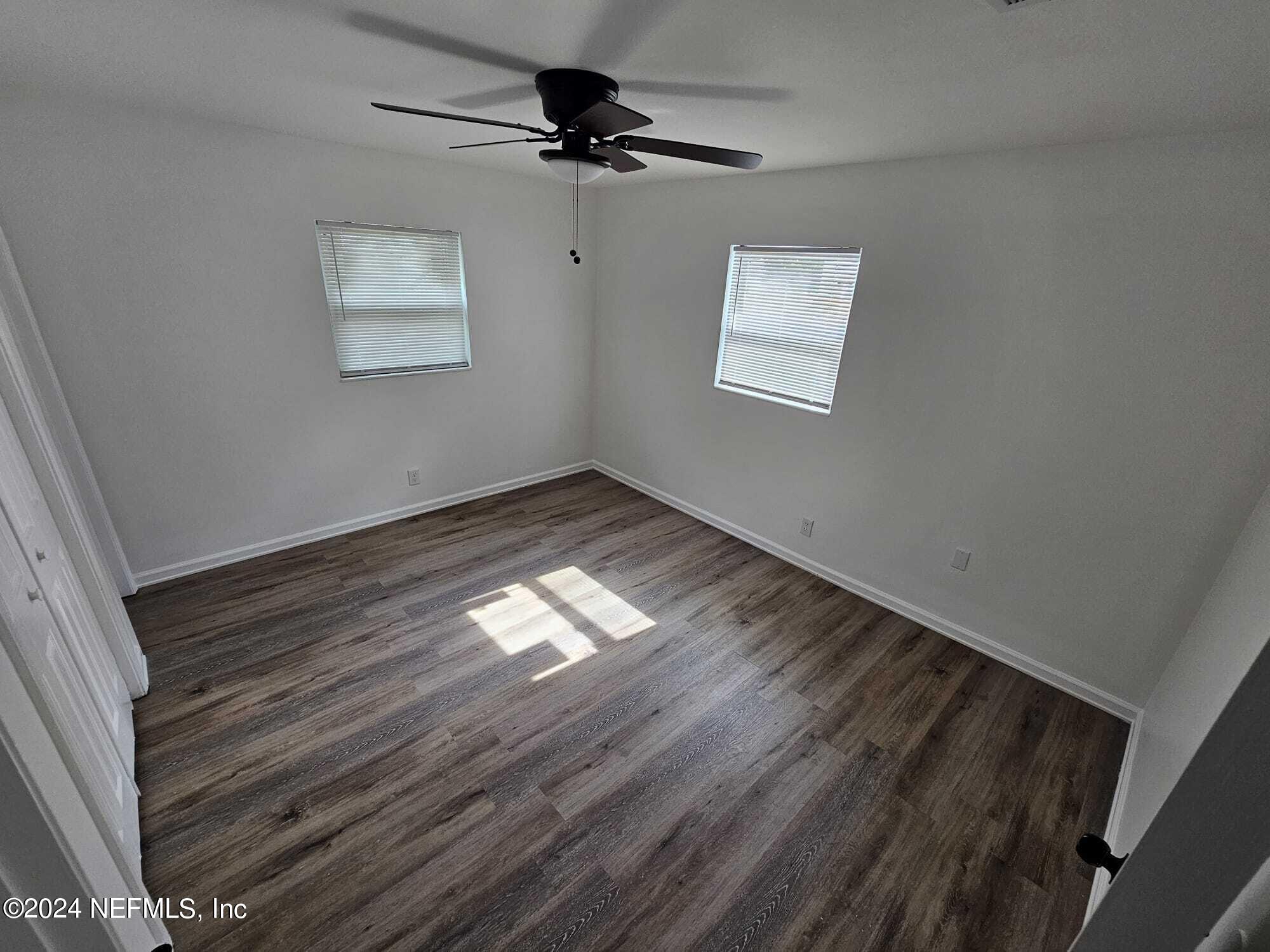 7504 Wheat Road Jacksonville, FL 32244 - Photo 11 of 31 a view of empty room with wooden floor and fan