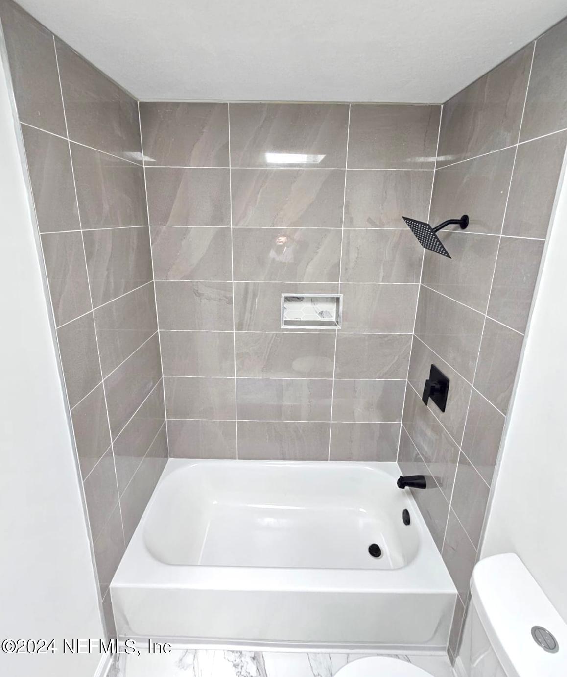 7504 Wheat Road Jacksonville, FL 32244 - Photo 14 of 31 a bathroom with a bathtub