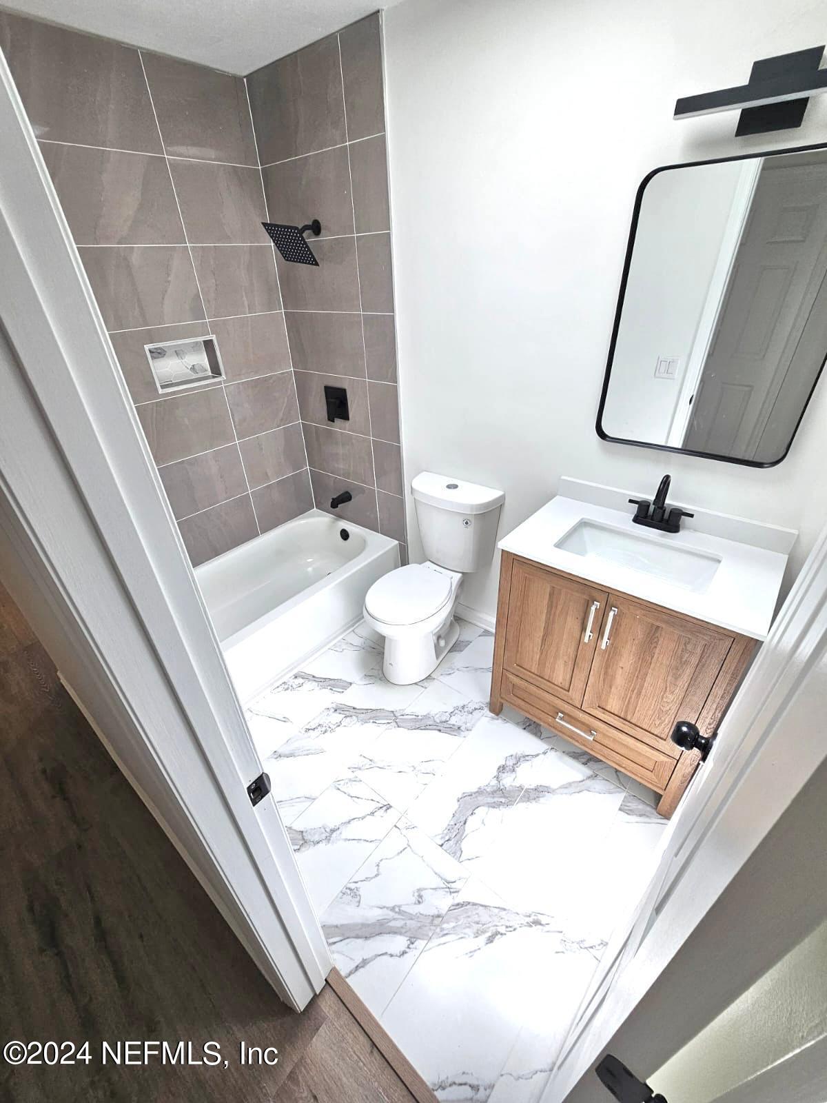 7504 Wheat Road Jacksonville, FL 32244 - Photo 16 of 31 a bathroom with a granite countertop sink and a mirror