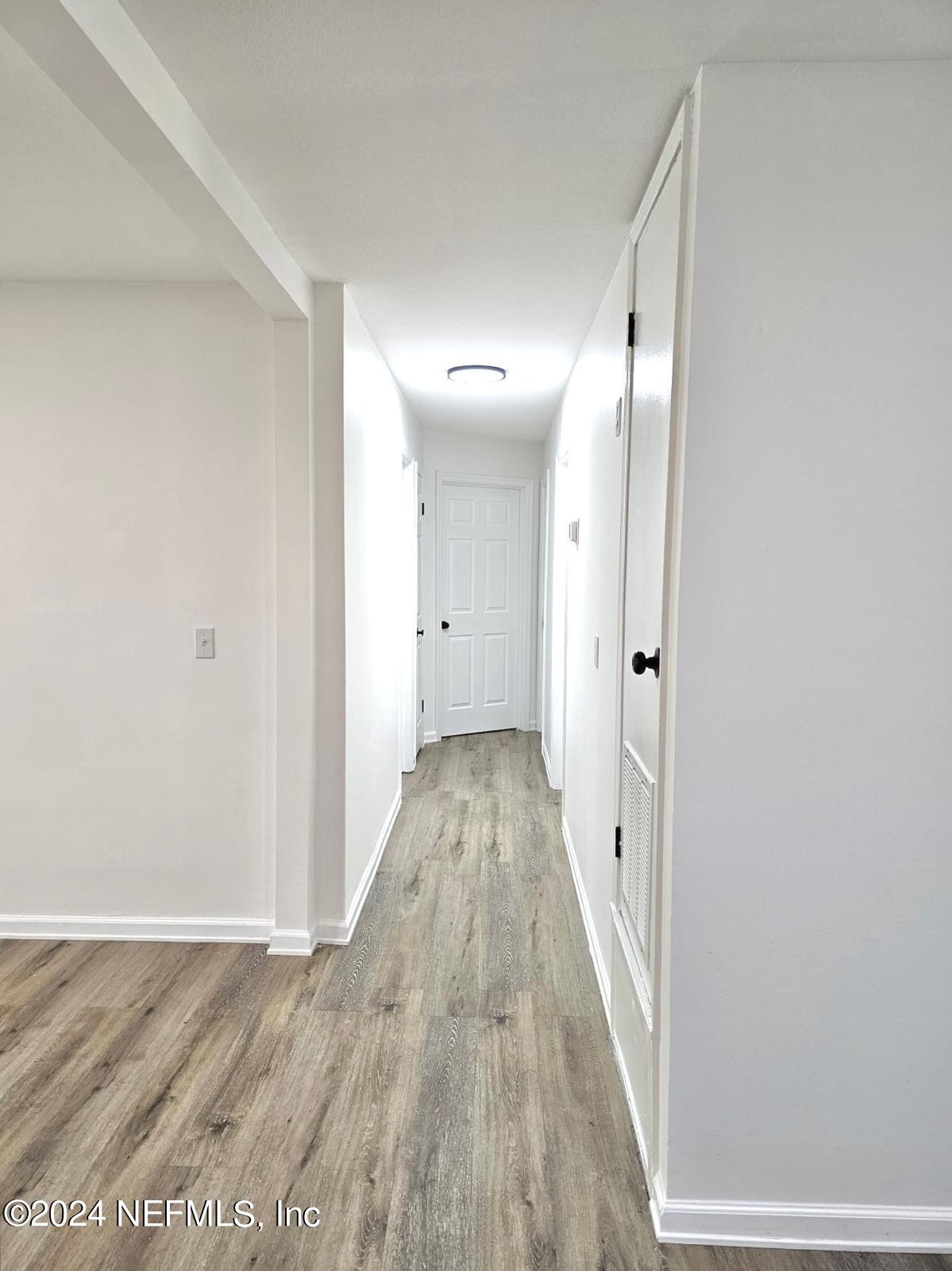 7504 Wheat Road Jacksonville, FL 32244 - Photo 17 of 31 a view of a hallway with wooden floor