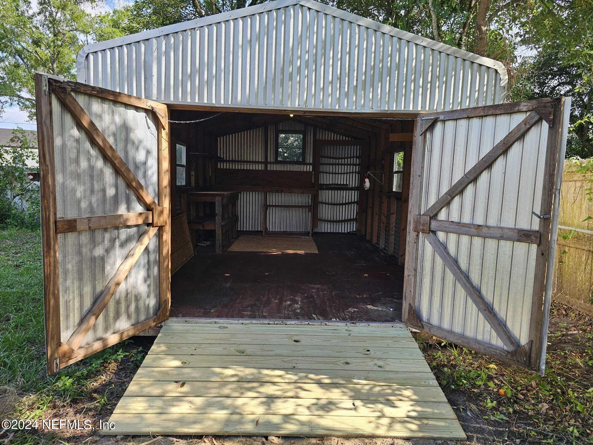 7504 Wheat Road Jacksonville, FL 32244 - Photo 26 of 31 a view of a small house with wooden wall
