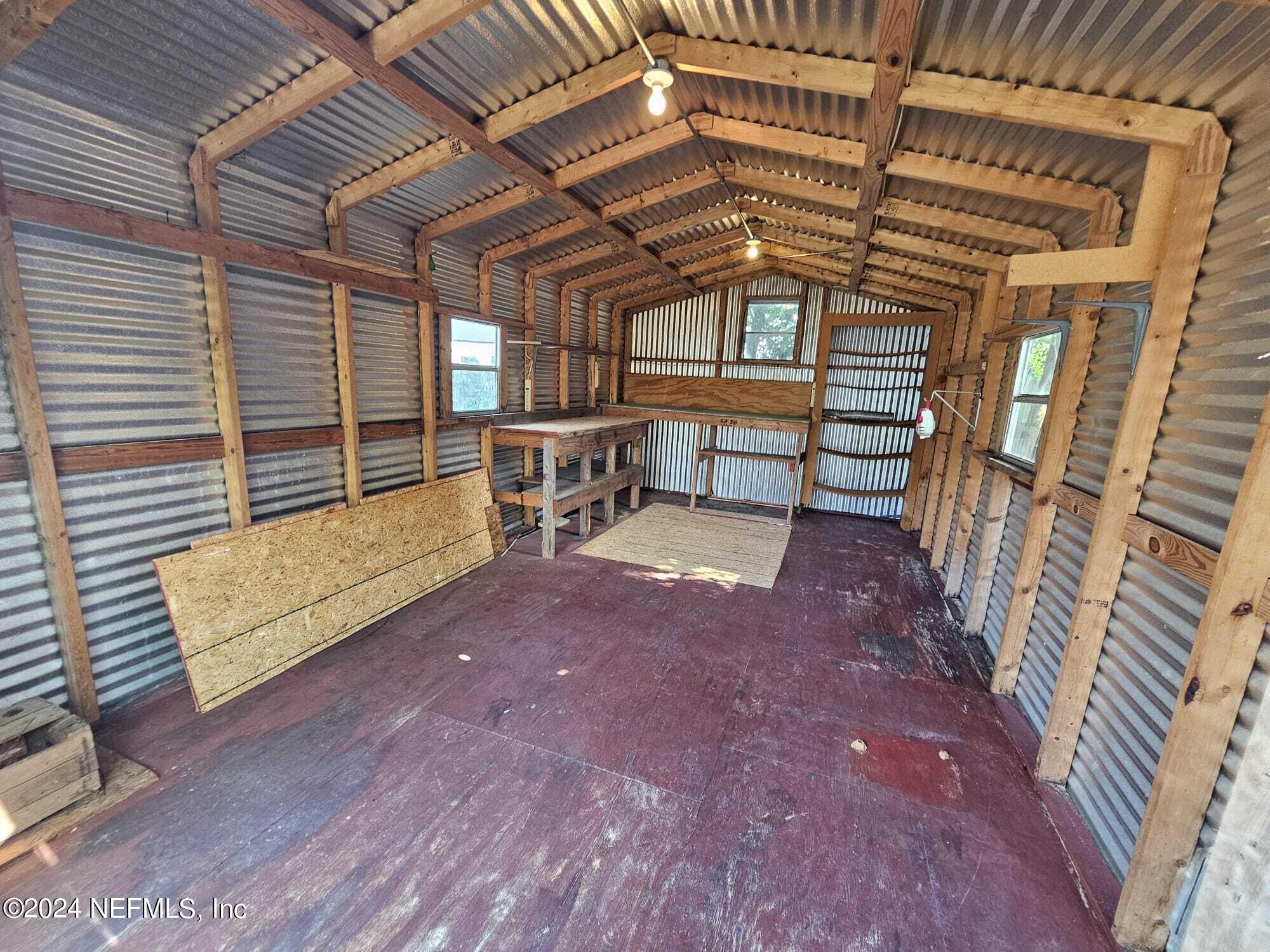 7504 Wheat Road Jacksonville, FL 32244 - Photo 27 of 31 a view of a patio with table and chairs with wooden floor and fence