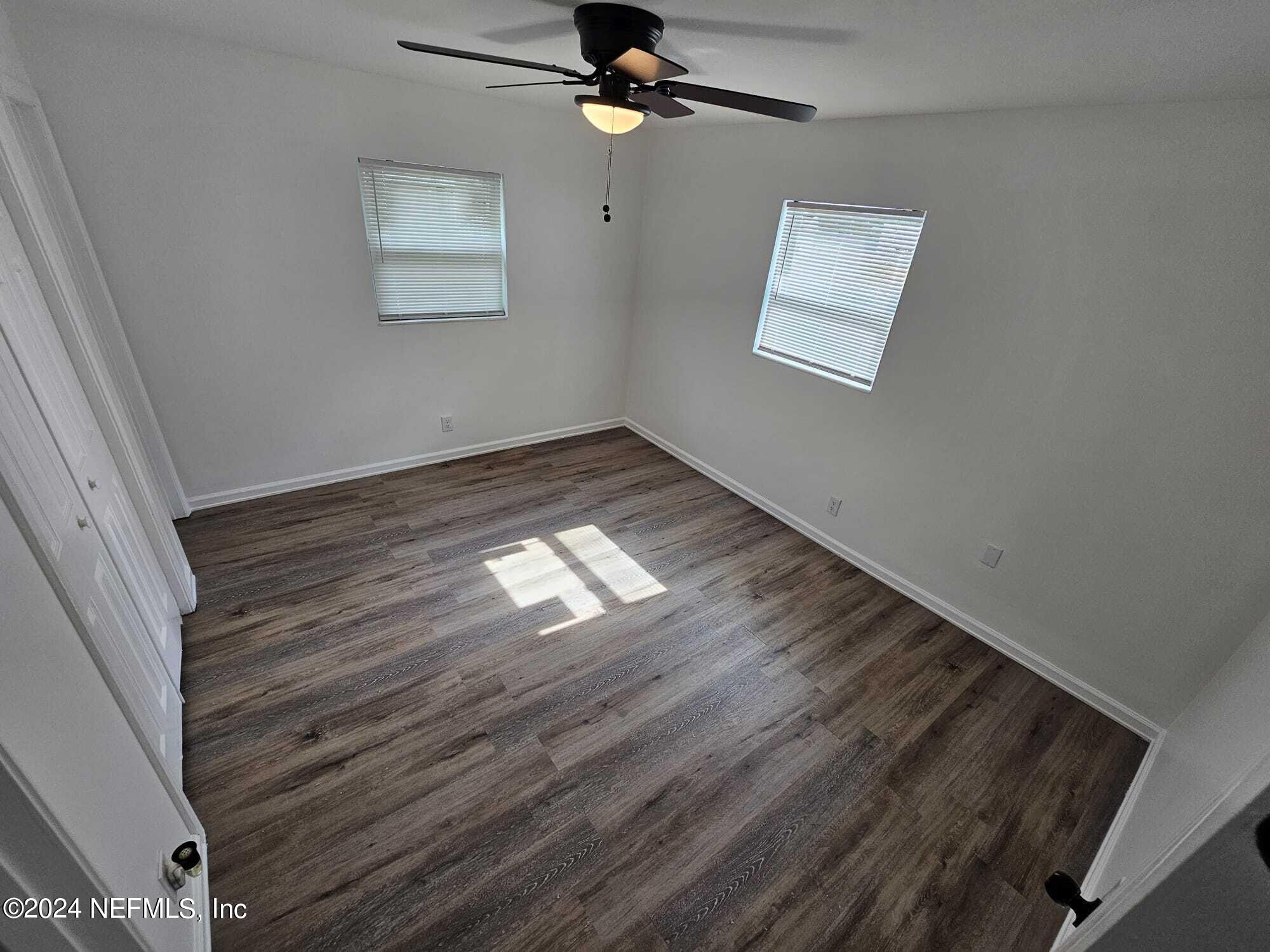 7504 Wheat Road Jacksonville, FL 32244 - Photo 30 of 31 a view of empty room with wooden floor