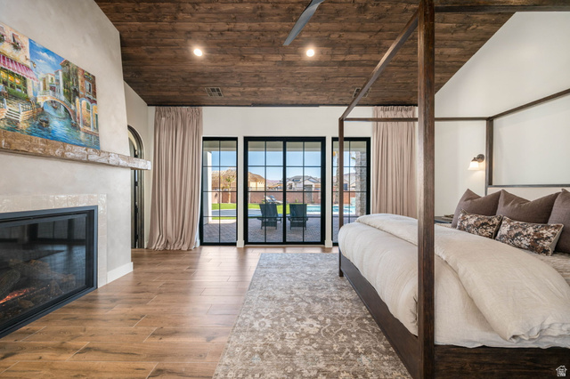 4871 South Homestead Way Washington, UT 84780 - Photo 38 of 151 Bedroom with a vaulted wood ceiling, wood finished floors, a glass covered fireplace, access to outside, and recessed lighting
