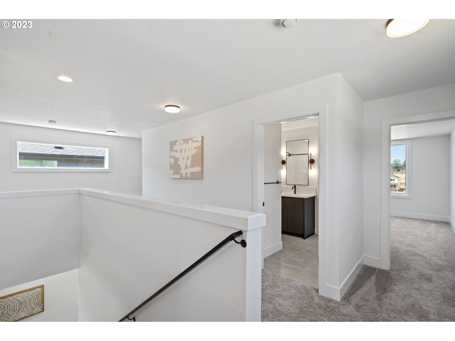 711 Northwest 175th Way Ridgefield, WA 98642 - Photo 16 of 21 a view of a hallway with wooden floor and kitchen