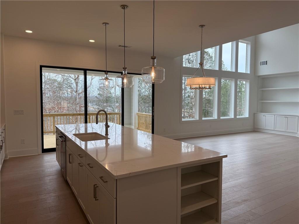1168 Ridgeview Road Woodstock, GA 30188 - Photo 12 of 17 a large kitchen with kitchen island a large window a sink and stainless steel appliances