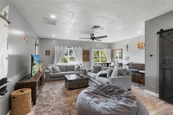 a living room with furniture ceiling fan and a rug