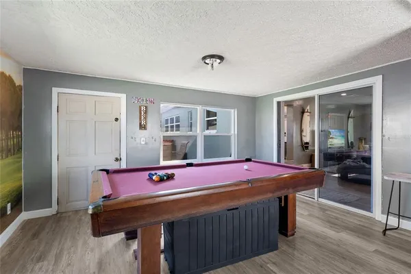 a room with a table chairs and wooden floor