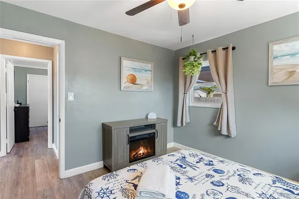 a bedroom with a bed and a fireplace