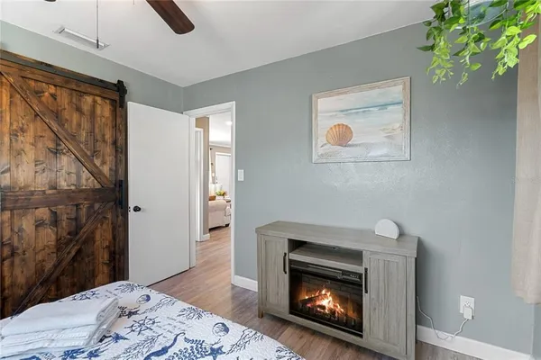 a room with a fireplace and a wooden floor
