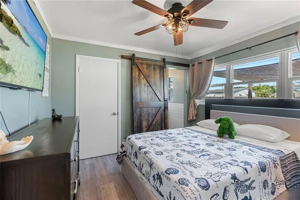 a bedroom with a bed and a chandelier